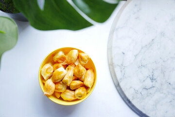 top view of slice of jackfruits in a bowl on table.