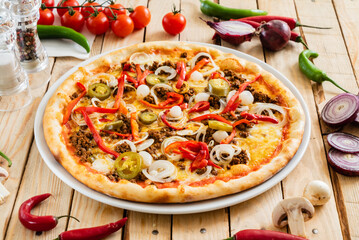 tasty pizza on the wooden background