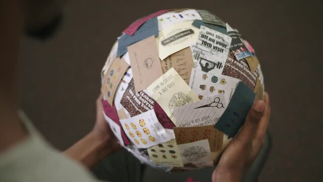 Hands holding ball of gift cards, Nottingham, Nottinghamshire, UK