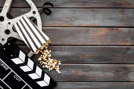 Movie film reel with clapperboard and popcorn. Cinema concept