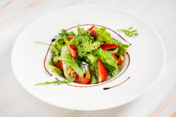 healthy salad with strawberriesa and arugula