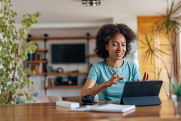 Adult woman, mentoring her juniors, from home office.