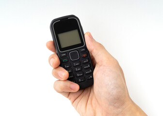 Hand a man holding of outdated mobile phone isolated on white background.