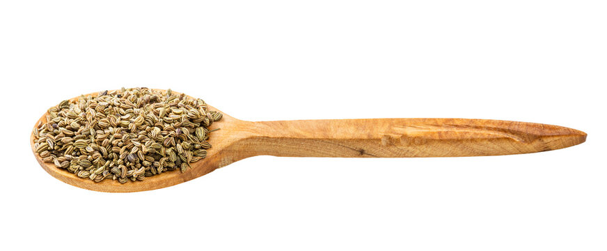 wooden spoon with ajwain seeds isolated
