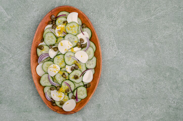 Salad of cucumbers, cheese, capers and lemon zest