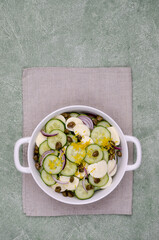 Salad of cucumbers, cheese, capers and lemon zest