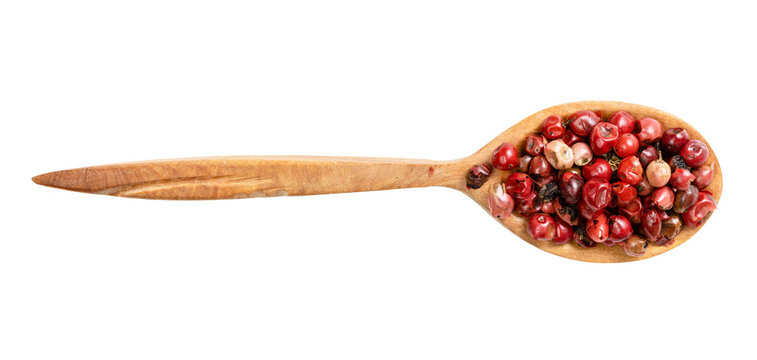 top view of wood spoon with pink peppercorns