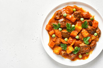 Beef stew with potatoes and carrots in tomato sauce