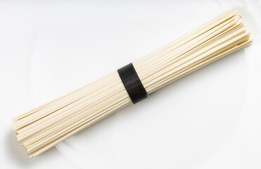bunch of round Udon noodles from wheat on plate