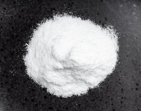 view of pile of dextrose sugar close up on black