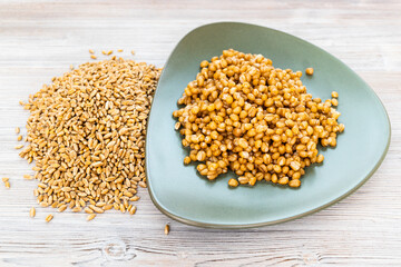 raw whole wheat grains and boiled porridge