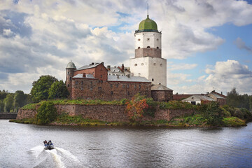 medieval swedish castle with St Olaf tower in Vyborg city and cutter at foreground.