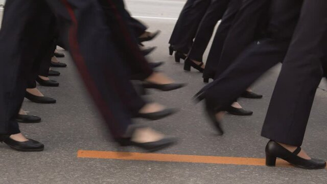Female march on military parade in uniform on the town square. Close-up of female legs in heels stepping to the rhythm.