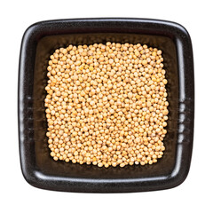 white mustard seeds in black bowl isolated
