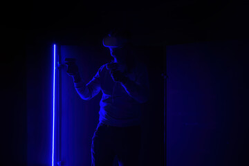 Man in virtual reality headset with joysticks