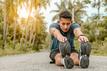 Sport man is stretching leg and relaxing before exercise.