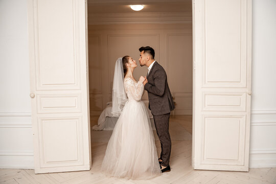 Full Length View Of Young Newlyweds Holding Hands Near Entrance To Bedroom