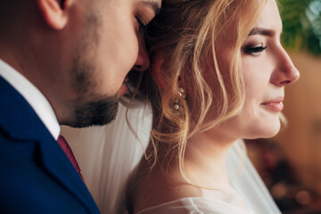 bride and groom hugging in a cozy room