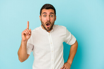 Young caucasian man isolated on blue background having an idea, inspiration concept.