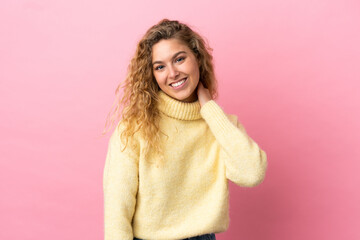 Young blonde woman isolated on pink background laughing