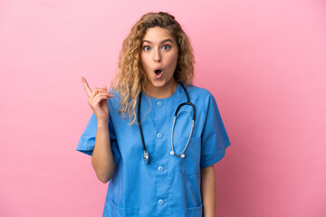 Young surgeon doctor woman isolated on pink background intending to realizes the solution while lifting a finger up