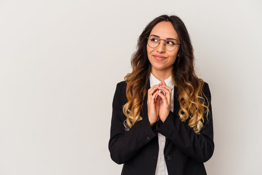 Young mexican business woman isolated on white background making up plan in mind, setting up an idea.