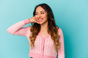 Young mexican woman isolated on blue background showing a mobile phone call gesture with fingers.