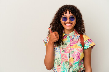 Young mixed race woman wearing sunglasses taking a vacation isolated smiling and raising thumb up