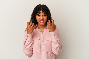 Young mixed race woman isolated on white background upset screaming with tense hands.