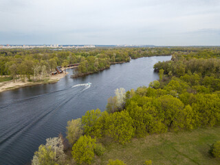 Fototapeta premium Motor boat with water skis on the river. Aerial drone view.