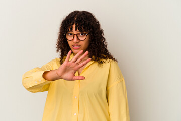 Young mixed race woman isolated on white background rejecting someone showing a gesture of disgust.