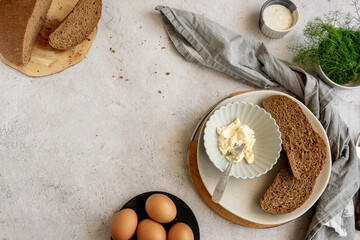Fototapeta na wymiar Ingredients for healthy farm cooking - eggs, whole wheat black bread, goat cream cheese and fresh raw fennel