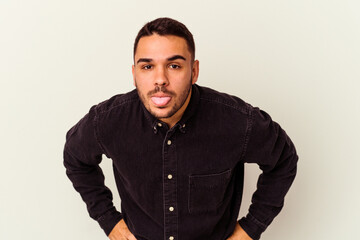 Young caucasian man isolated on white background funny and friendly sticking out tongue.