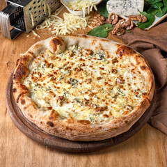 Four Cheese Pizza or Quattro Formaggi Pizza topped with tomato sauce, mozzarella, gorgonzola,...
