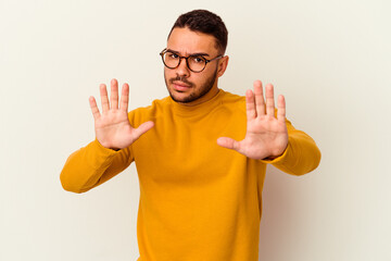 Young caucasian man isolated on white background being shocked due to an imminent danger