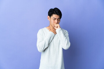 Young Chinese man isolated on purple background coughing a lot