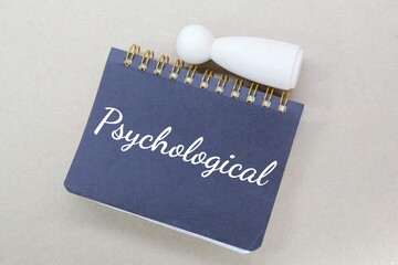 notebooks, peg puppets with the word Psychological and a brown background