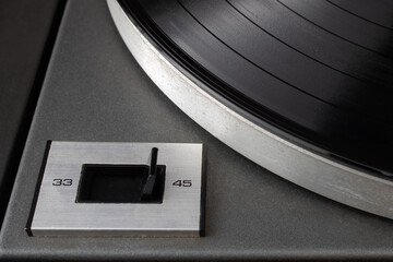 Close-up of speed rotation switch set to 45 RPM on vintage turntable vinyl record player