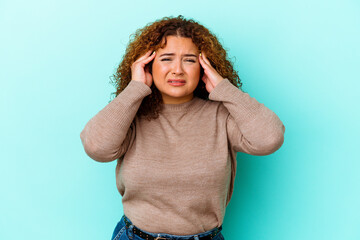 Young latin curvy woman isolated on blue background crying, unhappy with something, agony and confusion concept.