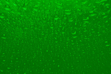 Saturated green wet texture with gradient and drops. Acid summer or nuclear waste color background.