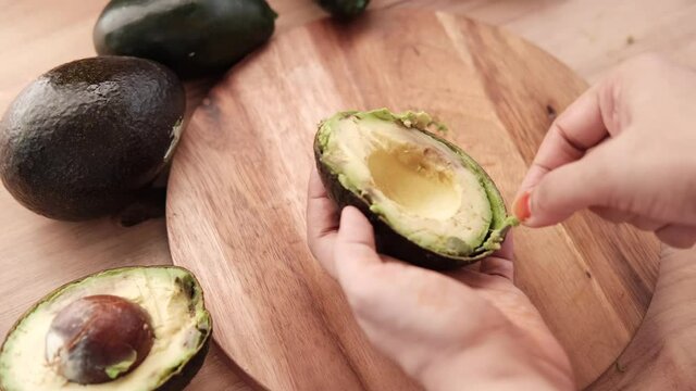 close up of slice of avocado on women's table 