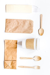breakfast take away with paper bags on white table background top view mock up