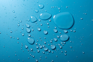 Water drop on blue background. Round water drop. Water background