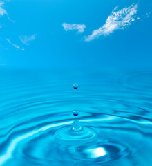 Naklejka na ściany i meble Water drop splash blue colored. Round water drop. Water background
