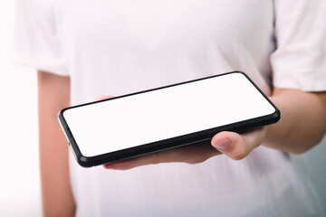Woman hand holding the black smartphone with blank screen  isolated on white background
