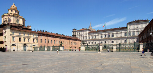 Fototapeta na wymiar gate of the Royal Palace, statues of the Dioscuri, church and dome of San Lorenzo and Palazzo Reale in Piazza Castello.
