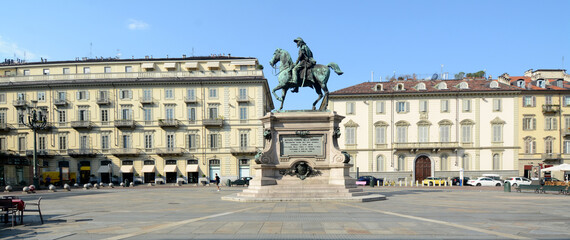 Fototapeta na wymiar Piazza Bodoni with the elegant buildings and the equestrian monument dedicated to Alfonso Ferrero Della Marmora.