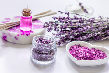 Obraz na płótnie Canvas lavender herbs in body care cosmetics with oil on white table background