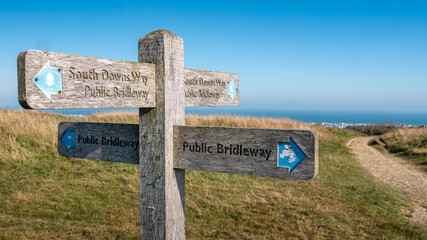 The South Downs way, Sussex, UK. A signpost giving directions to the 100 mile walking route between Winchester and Eastbourne, South East England. - obrazy, fototapety, plakaty