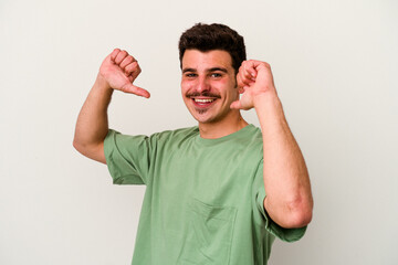 Young caucasian man isolated on white background feels proud and self confident, example to follow.